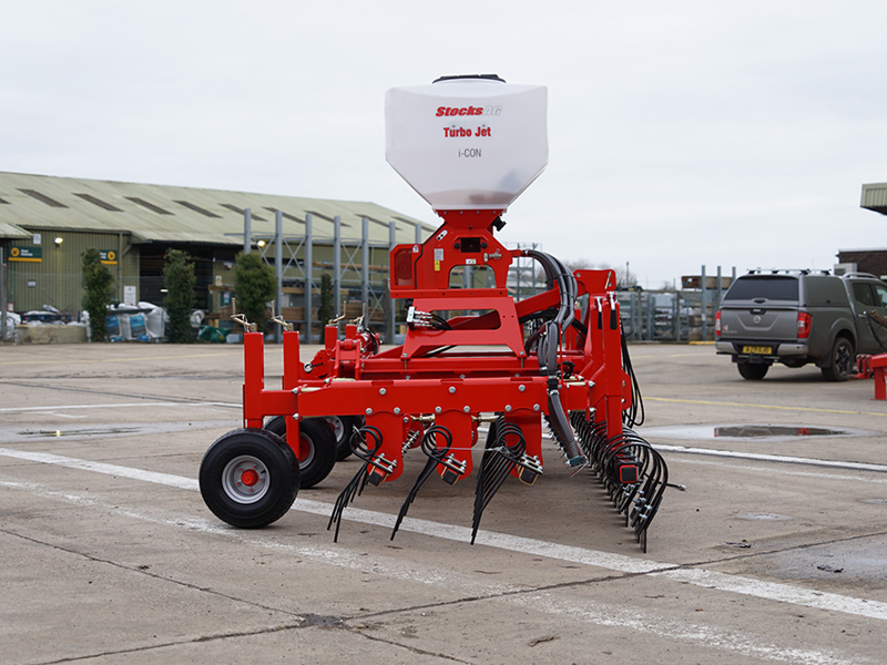Yard image of side of HE-VA Grass Combi fitted with Stocks Ag Turbo Jet 8 Applicator